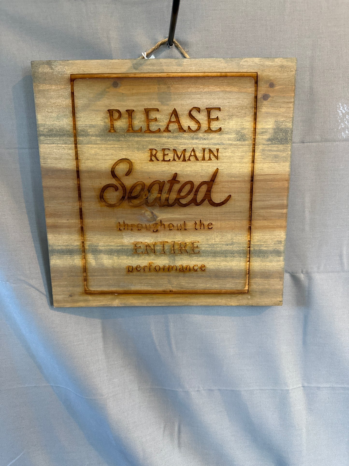 Please remain seated sign